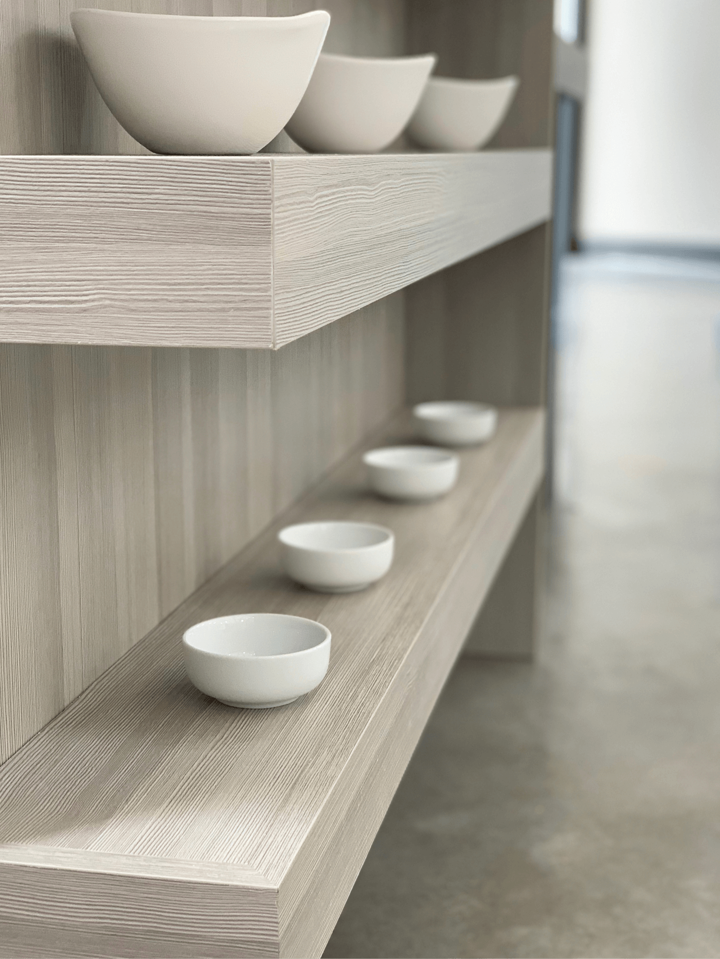 Floating shelves inside a modern kitchen display at Beck/Allen Cabinetry in St. Louis, MO.