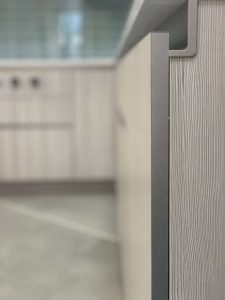 The GOLA channel system allows for a streamlined design free of cabinet hardware. Seen here, the system has been incorporared into a display at the Beck/Allen Cabinetry showroom in St. Louis, MO.