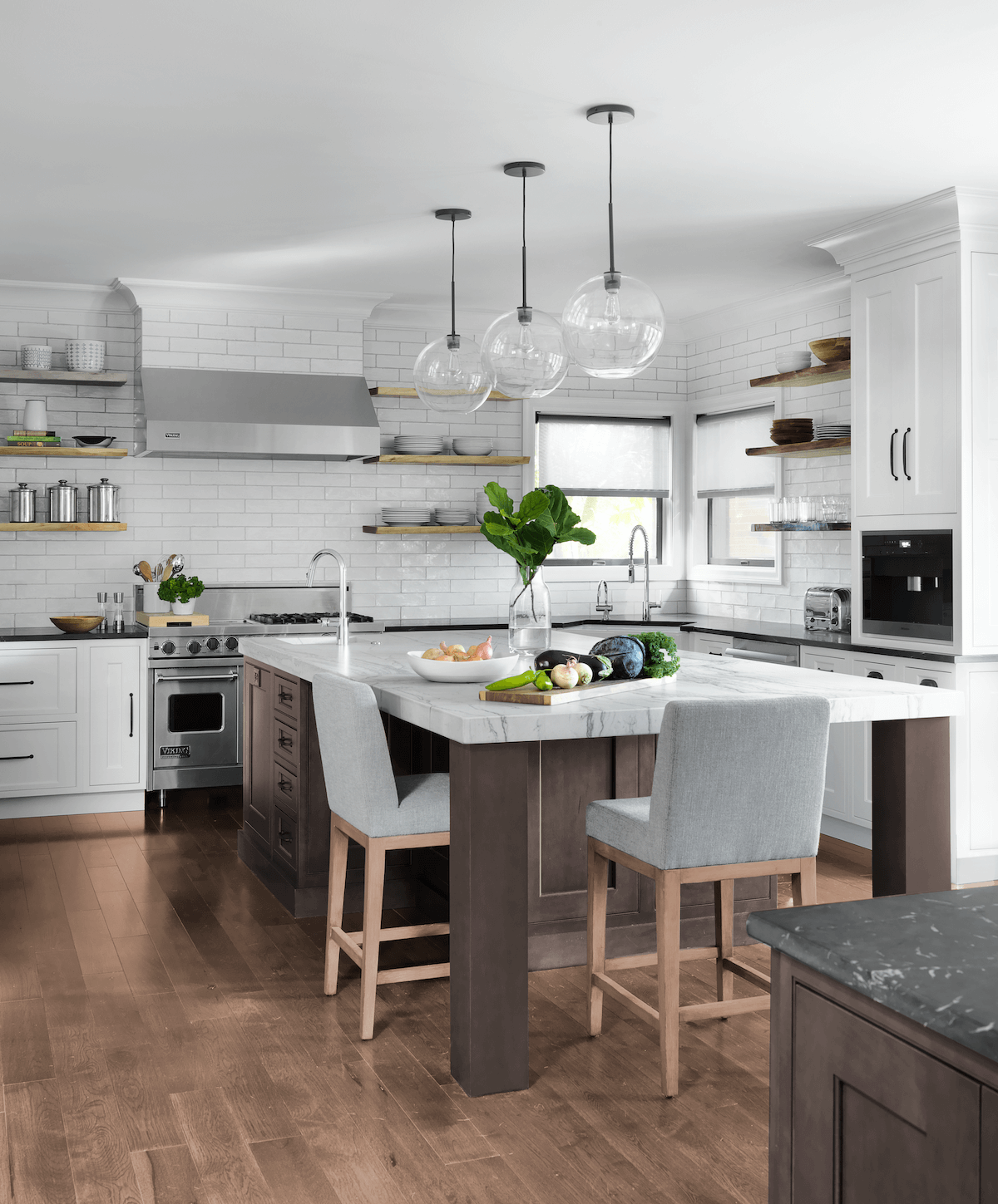 Bright white, casual family kitchen with an island large enough to seat a family of four.